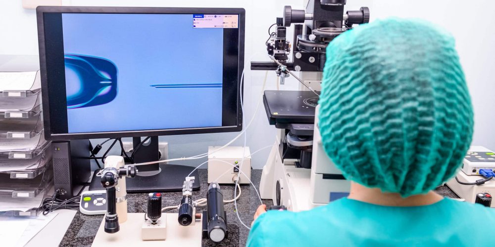 Embryologist Dr. Nishtha adding sperm to egg in laboratory of reproductive clinic. Selective focus